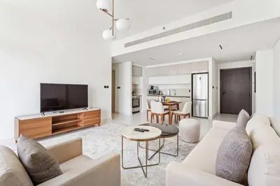 a living room with a couch and a tv at Silkhaus Marina View 1BDR Marina Vista Tower in Dubai