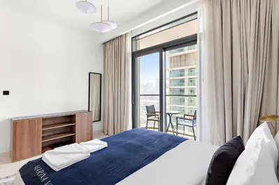 a bedroom with a bed and a large window at Silkhaus Mid Floor Marina Vista with Private Beach in Dubai