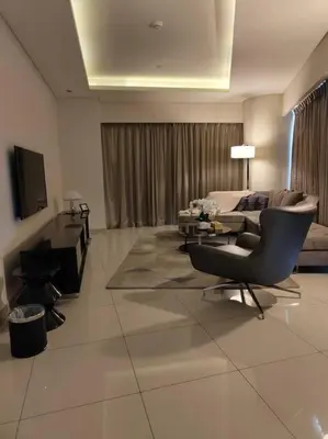 a living room with a couch and a chair at 2BR Tower D Paramount Apartment in Dubai