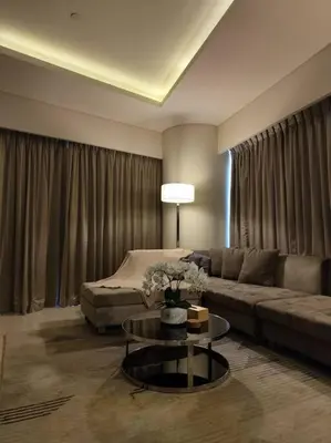 a living room with a couch and a table at 2BR Tower D Paramount Apartment in Dubai