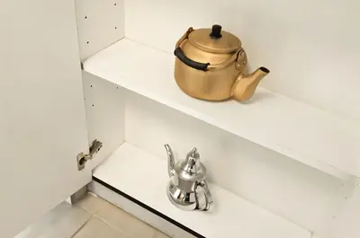 a tea kettle sitting on a shelf in a kitchen at 2BR Torch Tower High Floor Dubai Marina in Dubai