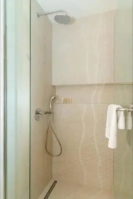 a shower with a glass door in a bathroom at AWS Holiday Homes - Oasis in the Palm in Dubai