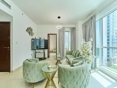 a living room with a couch and chairs and a tv at Golden homes Residences Tower 05 1BR CITY VIEW Near Dubai mall & burj khalifa in Dubai