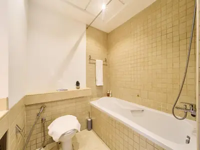 a bathroom with a bath tub and a toilet at Golden homes Residences Tower 05 1BR CITY VIEW Near Dubai mall & burj khalifa in Dubai