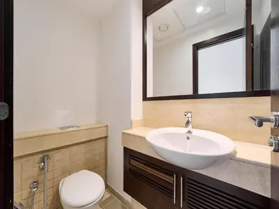 a bathroom with a sink and a toilet and a mirror at Golden homes Residences Tower 05 1BR CITY VIEW Near Dubai mall & burj khalifa in Dubai