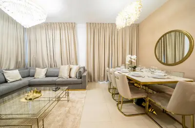 a living room with a couch and a dining table at NewArabian Dubai HillsMaple Villa in Dubai