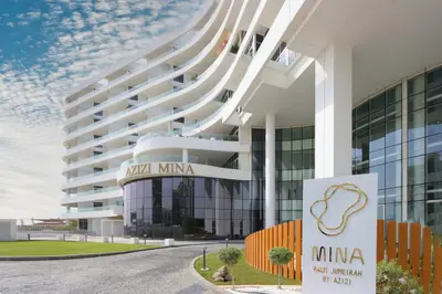 a building with a sign in front of it at Livbnb-Tranquil 1B Steps to PalmBoardwalk Sea View in Dubai