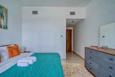 a bedroom with a bed with two towels on it at Aesthetic 2BR with Marina Waterfront View in Dubai