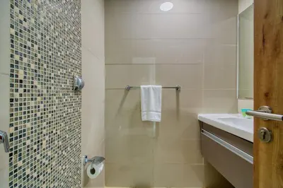 a bathroom with a shower with a sink and a toilet at Aesthetic 2BR with Marina Waterfront View in Dubai