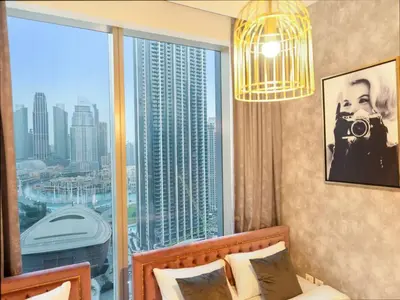 a bedroom with a large window with a view of a city at Panoramic Full Fountain,Opera& burj Sky View 4BR APT in Dubai