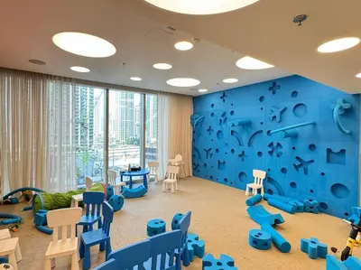 a childrens room with a blue wall at Panoramic Full Fountain,Opera& burj Sky View 4BR APT in Dubai