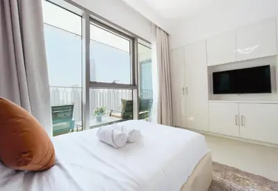 a bedroom with a white bed with towels on it at Stunning 2 Bedroom Apartment Downtown Views 2 - Tower 3 Downtown Dubai in Dubai