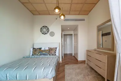 a bedroom with a bed and a dresser and a mirror at Exclusive front row seats to Burj Khalifa fireworks from penthouse level, downtown Dubai in Dubai