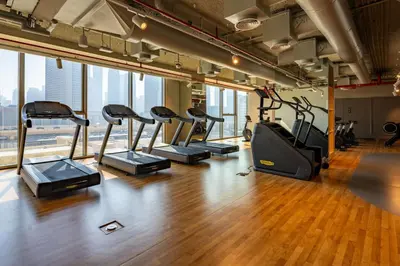 a gym with a row of treadmills and ellipticals at Exclusive front row seats to Burj Khalifa fireworks from penthouse level, downtown Dubai in Dubai