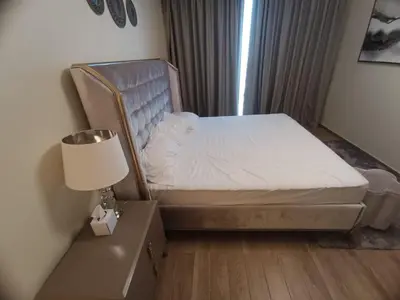 a small bedroom with a bed and a lamp at Al Quoz 2 Bed Budget Apartment in Dubai