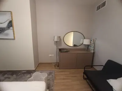 a living room with a mirror and a couch at Al Quoz 2 Bed Budget Apartment in Dubai