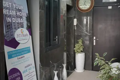a sign in front of a door with a clock at Ista Vacation Homes Rental LLC KARAMA in Dubai
