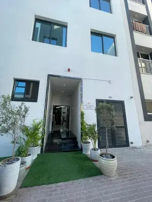 a white building with plants in front of it at Ista Vacation Homes Rental LLC KARAMA in Dubai