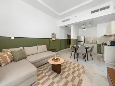 a living room with a couch and a table at Sukoon's Waterfront Two-Bedroom in Dubai