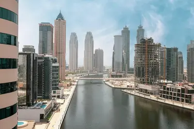 a river in the middle of a city with tall buildings at Sukoon's Waterfront Two-Bedroom in Dubai
