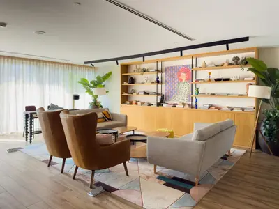 a living room with chairs and a table at Elite Escapes - Socio Stylish 1 BHK Getaway in Dubai