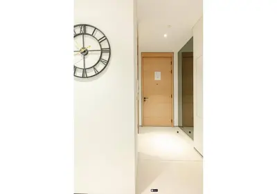 a clock on a wall next to a hallway at Premium Stay at The Address Residences JBR in Dubai
