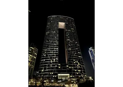 a tall building is lit up at night at Premium Stay at The Address Residences JBR in Dubai