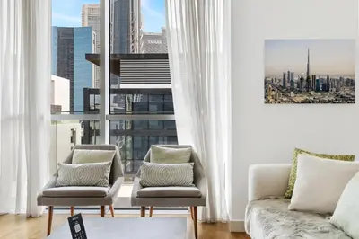 a living room with two chairs and a couch and a window at 2BR plus M with Huge Balcony City Walk Building 22 in Dubai