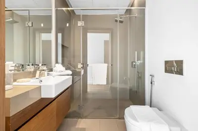 a bathroom with two sinks and a glass shower at 2BR plus M with Huge Balcony City Walk Building 22 in Dubai