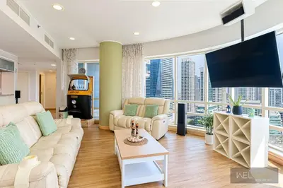 a living room with a couch and a large window at WelHome - Stylish Breathtaking 2BR Apartment in Marina in Dubai
