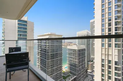 a balcony with a view of a city with tall buildings at Silkhaus 1BDR with Private Beach Skyline Views in Dubai