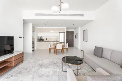 a living room with a couch and a table at Silkhaus 1BDR with Private Beach Skyline Views in Dubai