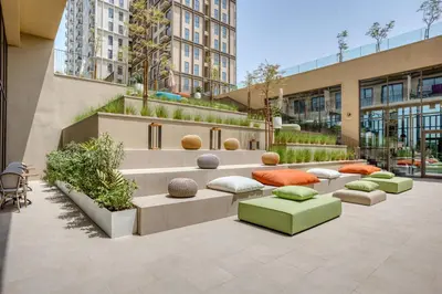 a seating area in a building with benches and pillows at Blueground Dubai Hills Estate balcony elev DXB-1120 in Dubai