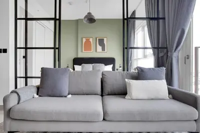 a couch with pillows in a room with a bed at Blueground Dubai Hills Estate balcony elev DXB-1120 in Dubai