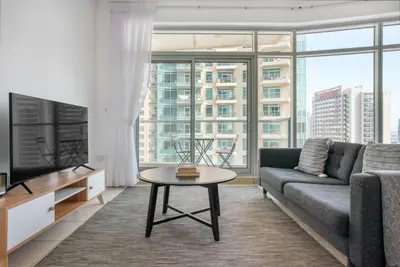 a living room with a couch and a table at Blueground Burj Views A sauna game room DXB-1386 in Dubai