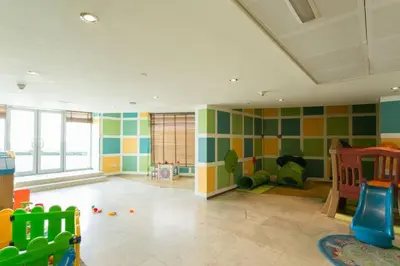 a room with a play room with a playground at Blueground Burj Views A sauna game room DXB-1386 in Dubai