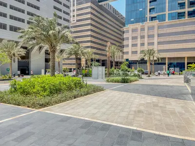 a street in a city with palm trees and buildings at Blueground Sheikh Zayed Rd pool gym DXB-545 in Dubai