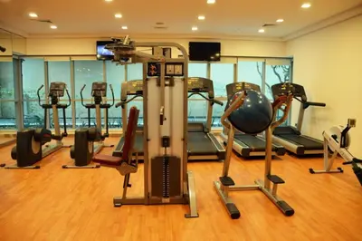 a gym with several exercise equipment in a room at Blueground Boulevard Central pool gym DXB-1179 in Dubai