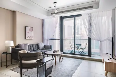 a living room with a couch and a large window at Blueground JLT lake view roof pool gym DXB-1546 in Dubai