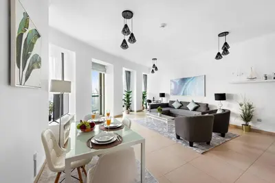 a living room with a table and a couch at Skyline Views 2BR Near Burj Khalifa & Dubai Mall with Pool Access in Dubai