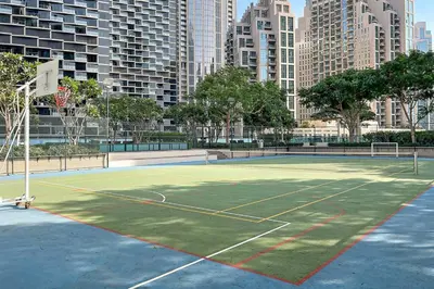a tennis court in the middle of a city at Skyline Views 2BR Near Burj Khalifa & Dubai Mall with Pool Access in Dubai