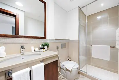 a bathroom with a toilet and a sink and a shower at Skyline Views 2BR Near Burj Khalifa & Dubai Mall with Pool Access in Dubai