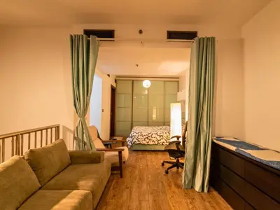 a living room with a couch and a bed at Al Barsha South Fourth in Dubai