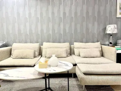 a living room with a couch and a table at Amazing Studio Apartment in The Crescent A Tower IMPZ in Dubai