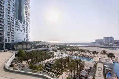 an aerial view of a resort with a beach and palm trees at Elegant Beachfront Living at Al Bateen in Dubai