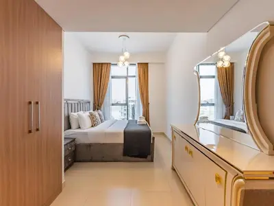 a hotel room with a bed and a mirror at Luxury Meydan Escape Condo with City Views in Dubai