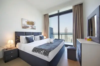 a bedroom with a large bed with a large window at Burj Vista Downtown Near To Dubai Mall - 2BHK in Dubai