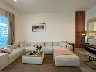 a living room with a couch and a table at Cozy 2BHK with Marina Views in Dubai