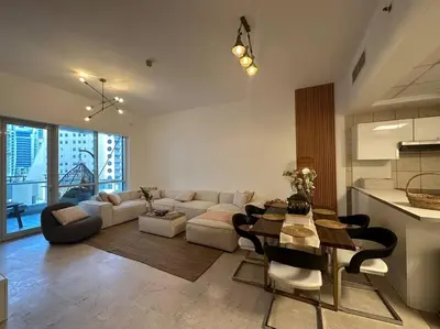 a living room with a couch and a table at Cozy 2BHK with Marina Views in Dubai
