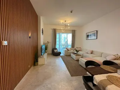 a living room with a couch and a table at Cozy 2BHK with Marina Views in Dubai